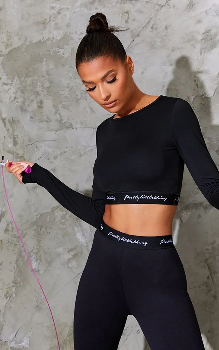 PRETTYLITTLETHING Sport - Crop top manches longues noir à bande élastique PRETTYLITTLETHING