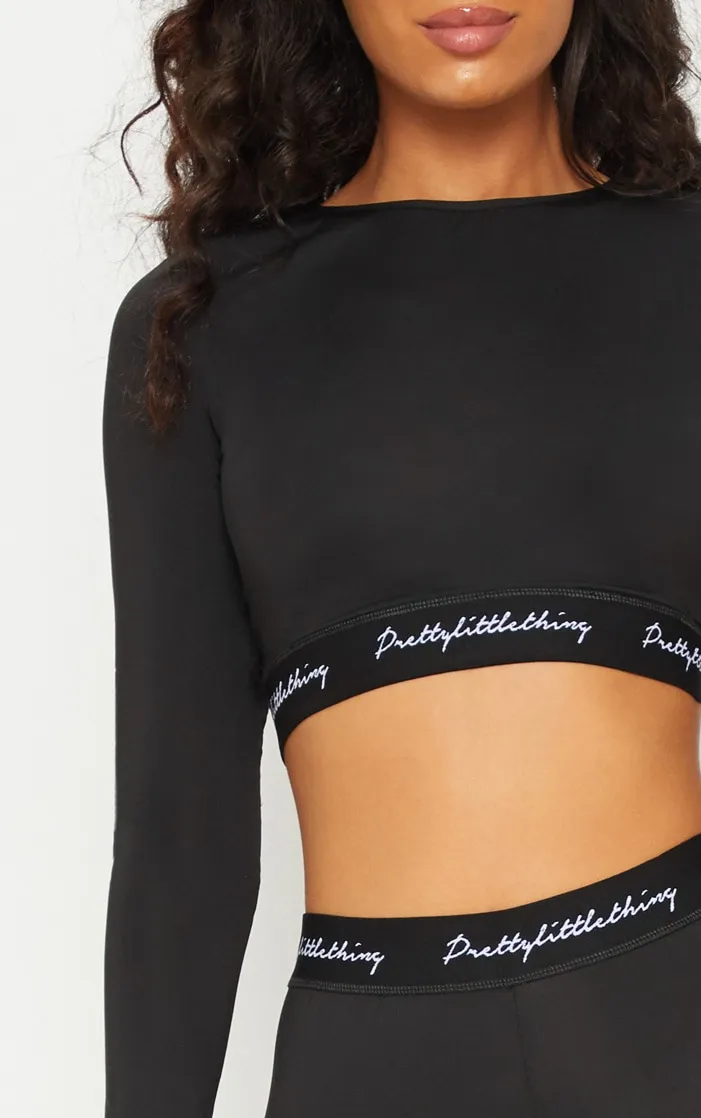 PRETTYLITTLETHING Sport - Crop top manches longues noir à bande élastique PRETTYLITTLETHING